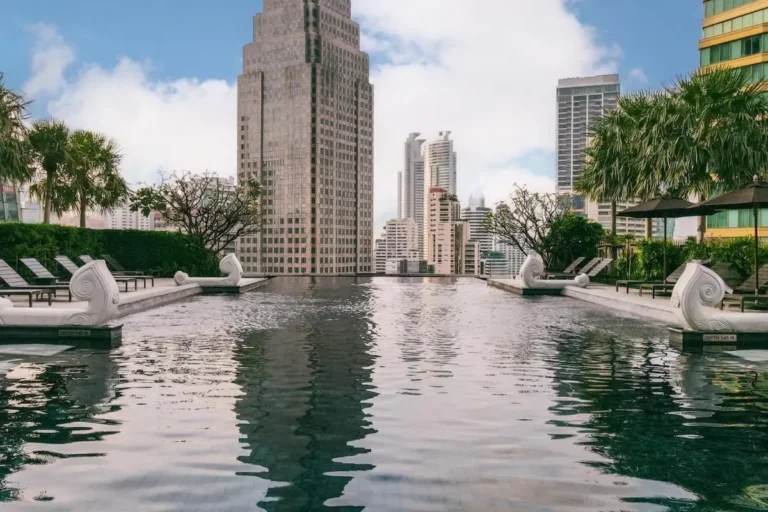 Rooftop Infinity Pool with Lounge Seating and Urban Views in Wattana Bangkok