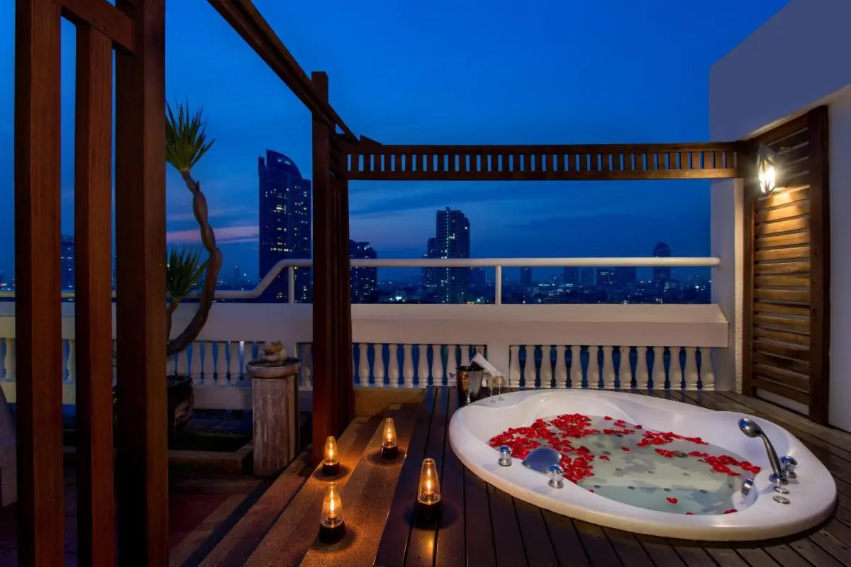 Ramada Plaza by Wyndham Bangkok Menam Riverside Rooftop Jacuzzi with City Skyline Views and Ambient Lighting in Bang Kho Laem Thailand