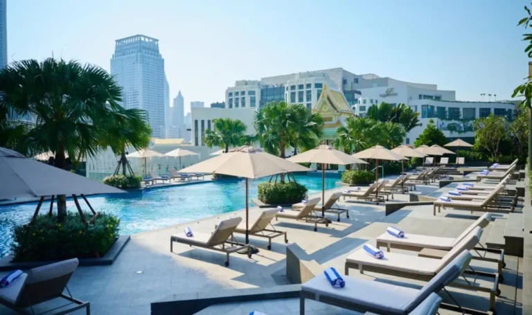 Rooftop Outdoor Pool Area with Sun Loungers and Urban Views in Ratchathewi Bangkok