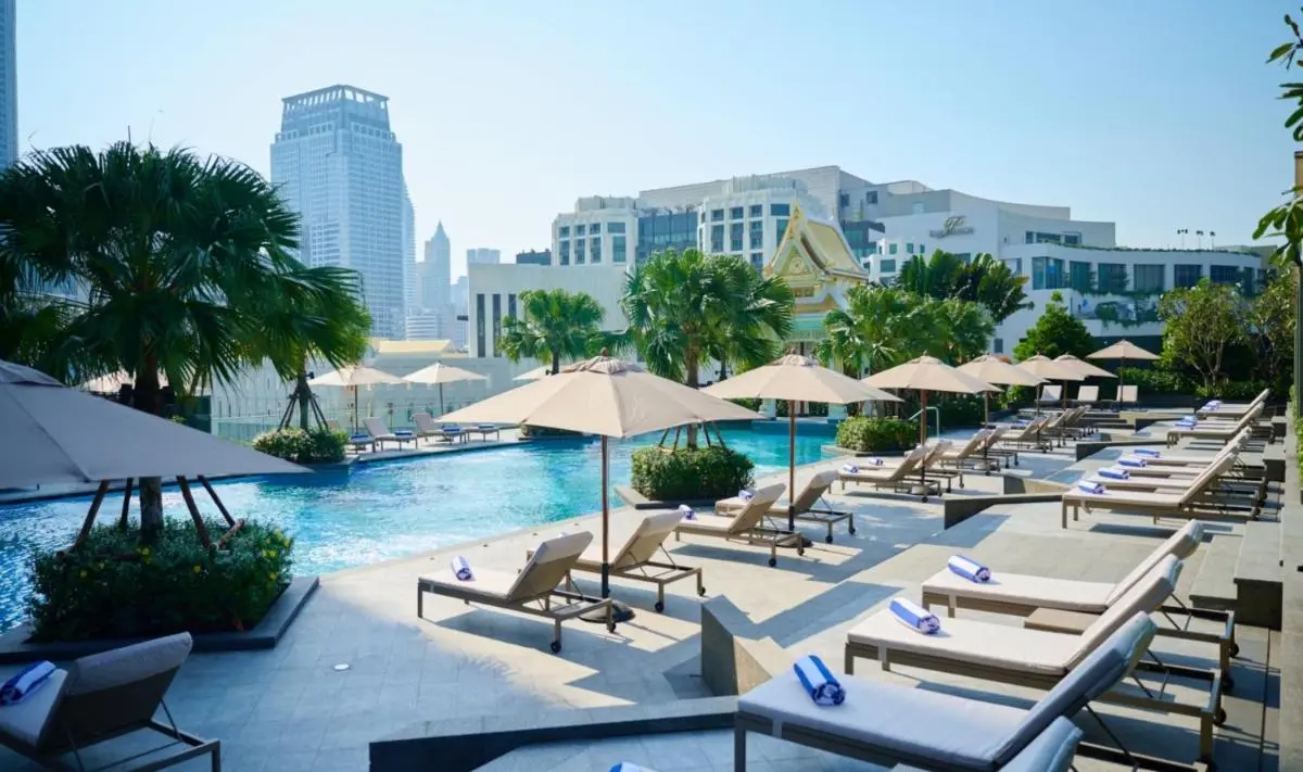 Chatrium Grand Bangkok Rooftop Outdoor Pool Area with Sun Loungers and Urban Views in Ratchathewi Bangkok