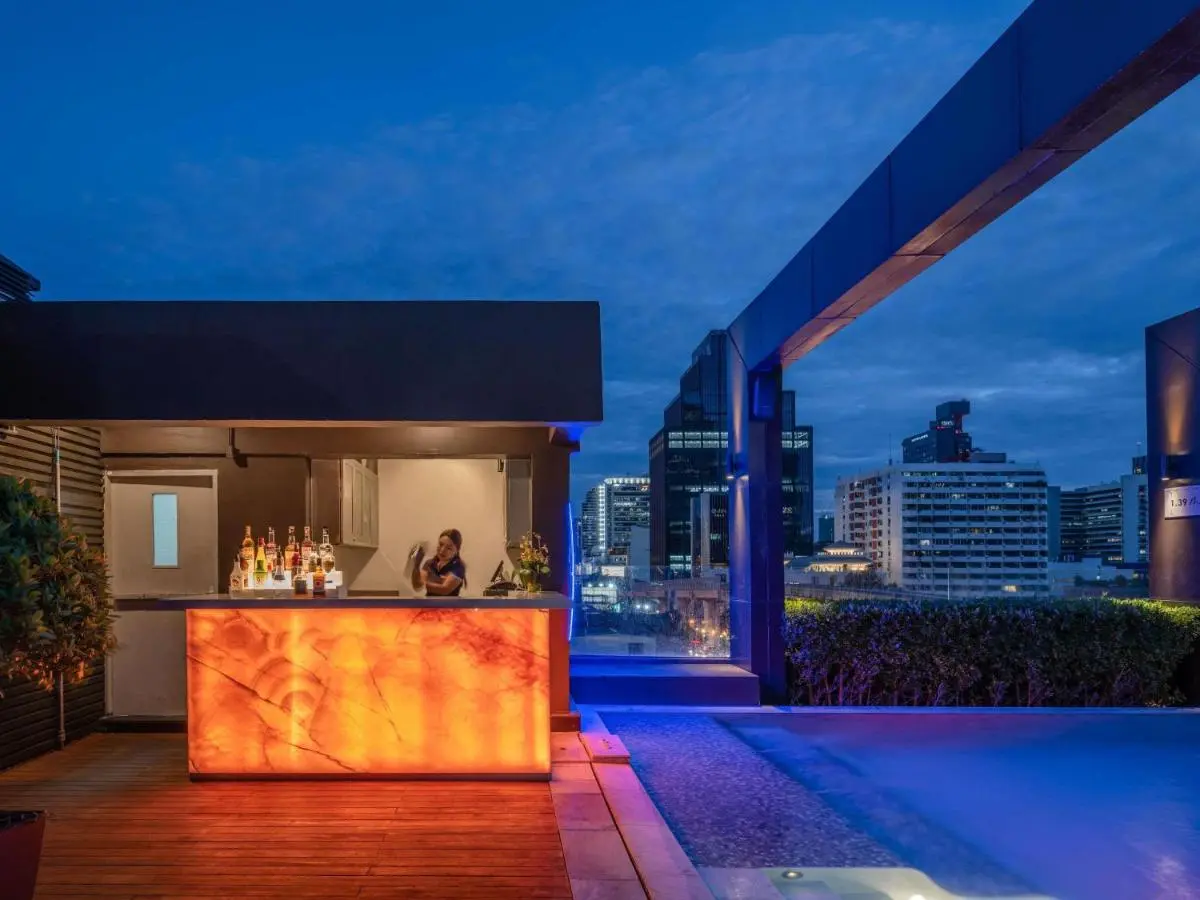 Rooftop Pool and Bar Area with Ambient Lighting in Ratchathewi Bangkok
