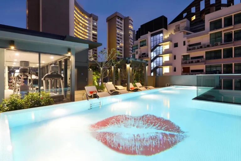Rooftop Pool and Fitness Area with Lounge Chairs and Urban Views in Singapore