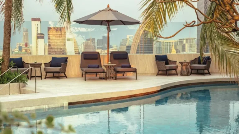 Rooftop Pool and Lounge Area with City Skyline Views in Pathumwan Bangkok