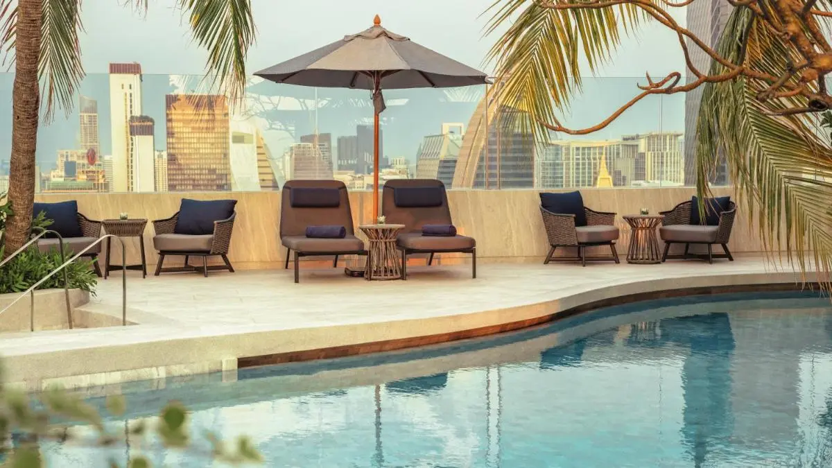 Rooftop Pool and Lounge Area with City Skyline Views in Pathumwan Bangkok