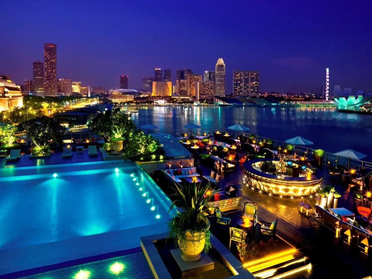 The Fullerton Bay Hotel Singapore Rooftop Pool and Outdoor Lounge with City Skyline View at Marina Bay