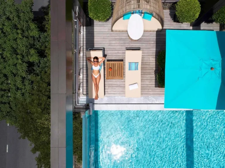 Rooftop Pool and Relaxation Area with Lounge Chairs and Daybed in Ratchathewi Bangkok
