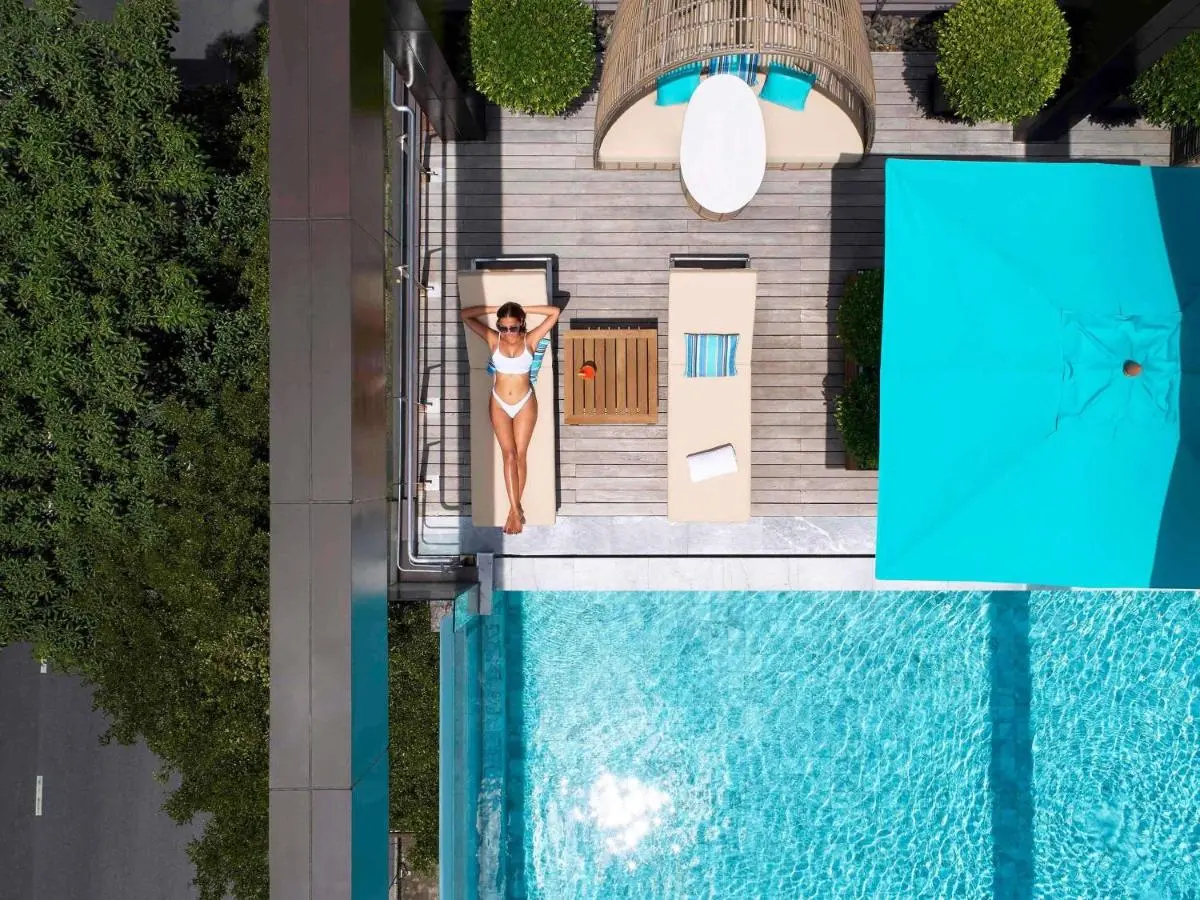 VIE Hotel Bangkok - MGallery Collection Rooftop Pool and Relaxation Area with Lounge Chairs and Daybed in Ratchathewi Bangkok