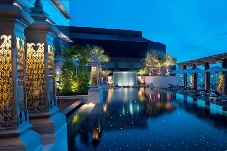 Rooftop Pool and Spa Area with Waterfall and Lounge Seating in Pathumwan Bangkok