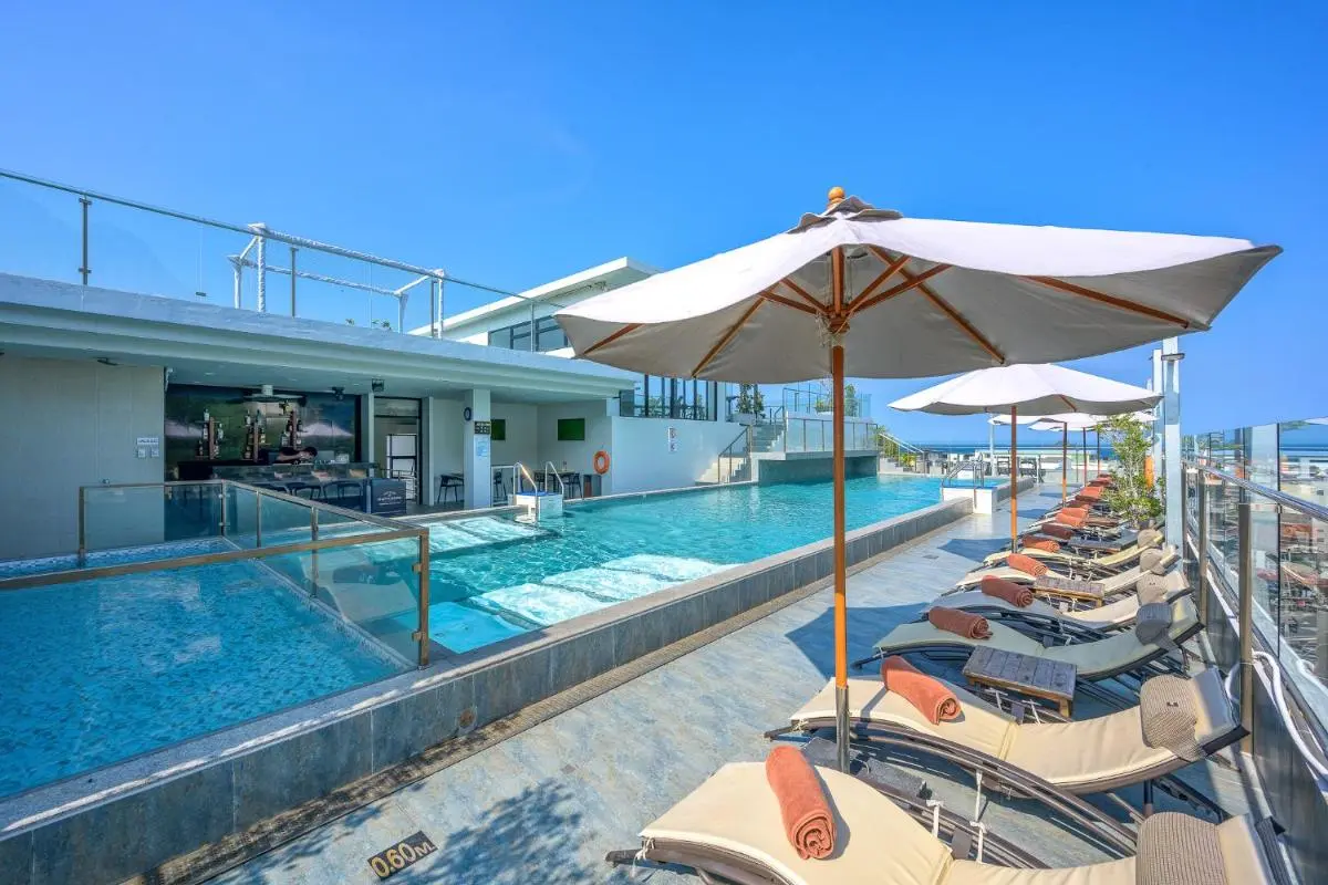 Rooftop Pool Area with Lounge Chairs and Ocean Views at Patong Beach