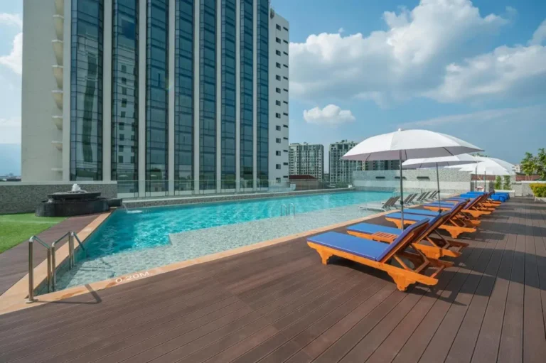 Rooftop Pool Area with Lounge Chairs and Water Feature in Chang Khlan Chiang Mai