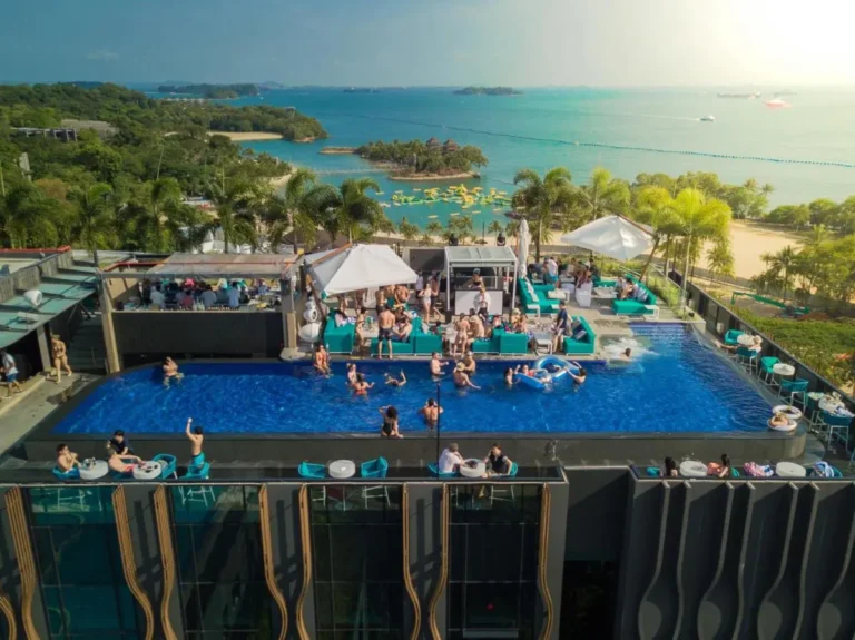 Rooftop Pool Area with Lounge Seating and Coastal Views on Sentosa Island