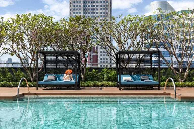 Rooftop Pool Area with Modern Cabanas and Urban Views in Wattana Bangkok