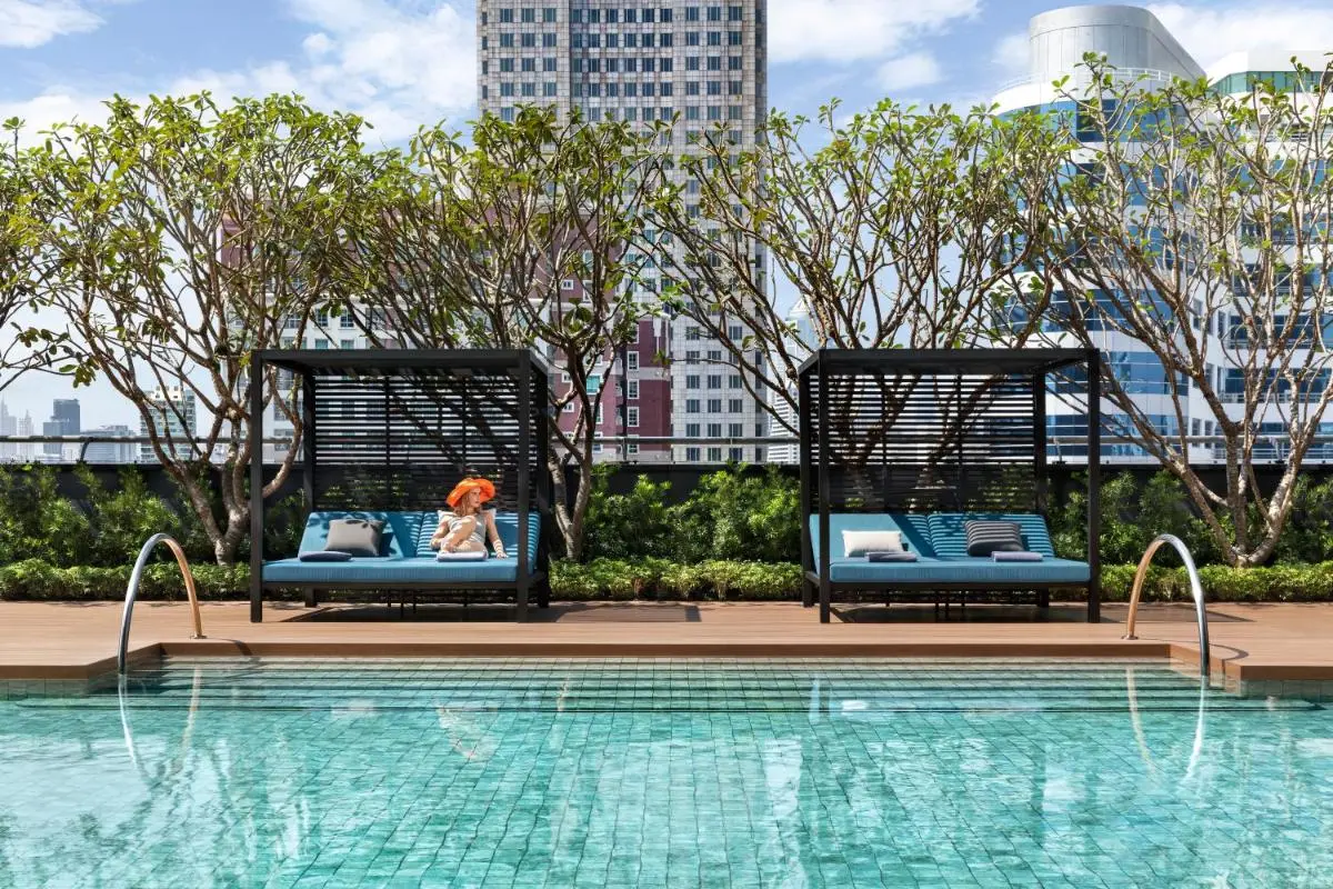 Rooftop Pool Area with Modern Cabanas and Urban Views in Wattana Bangkok