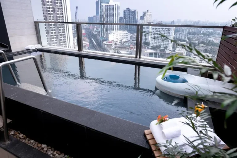 Rooftop Pool with Cityscape Views and Towel Arrangement in Wattana Bangkok