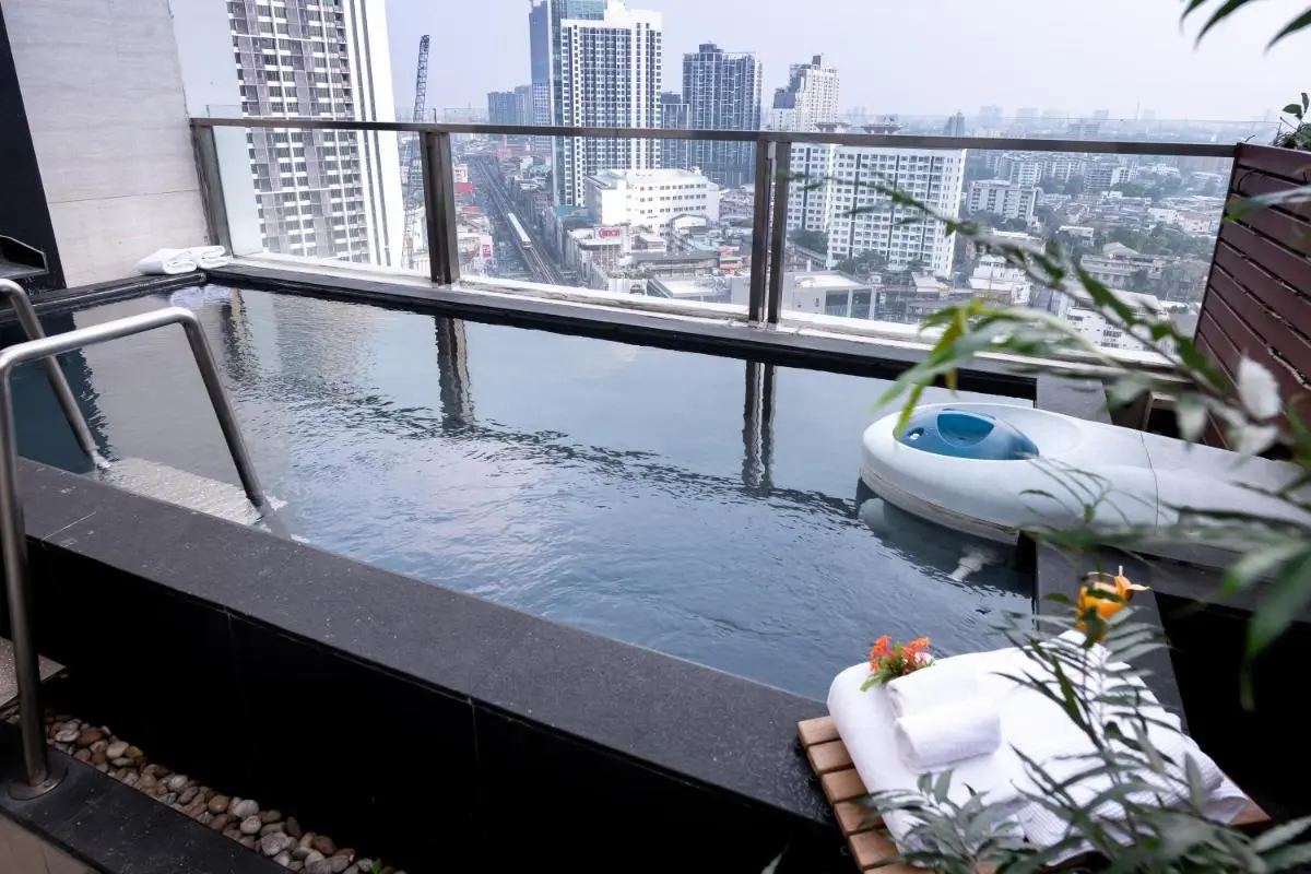 Jasmine Resort Bangkok Rooftop Pool with Cityscape Views and Towel Arrangement in Wattana Bangkok