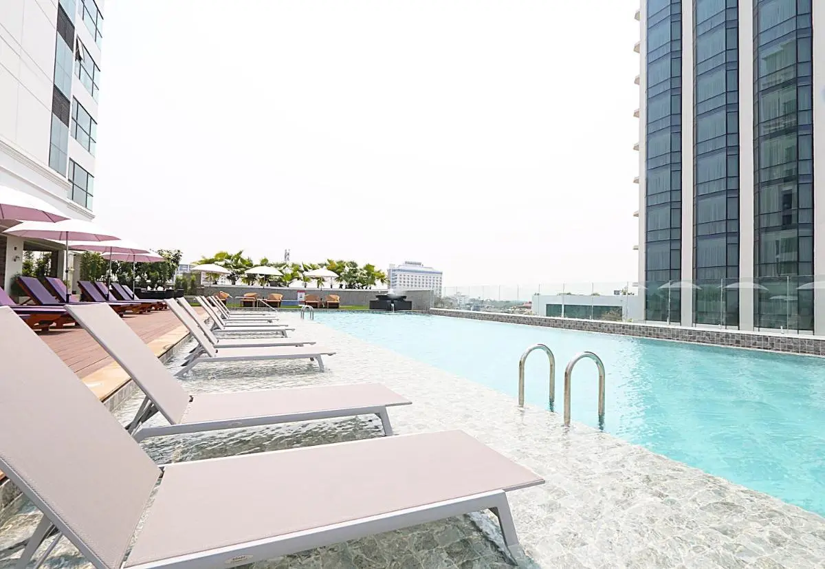 Rooftop Pool with Lounge Chairs and Urban Views in Chang Khlan Chiang Mai