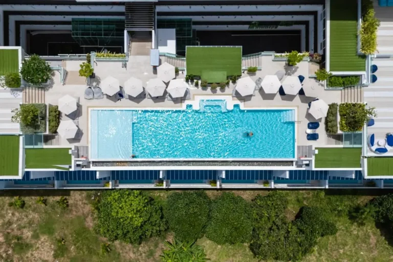 Rooftop Rectangular Swimming Pool with Lounge Area and Greenery at Rawai Beach