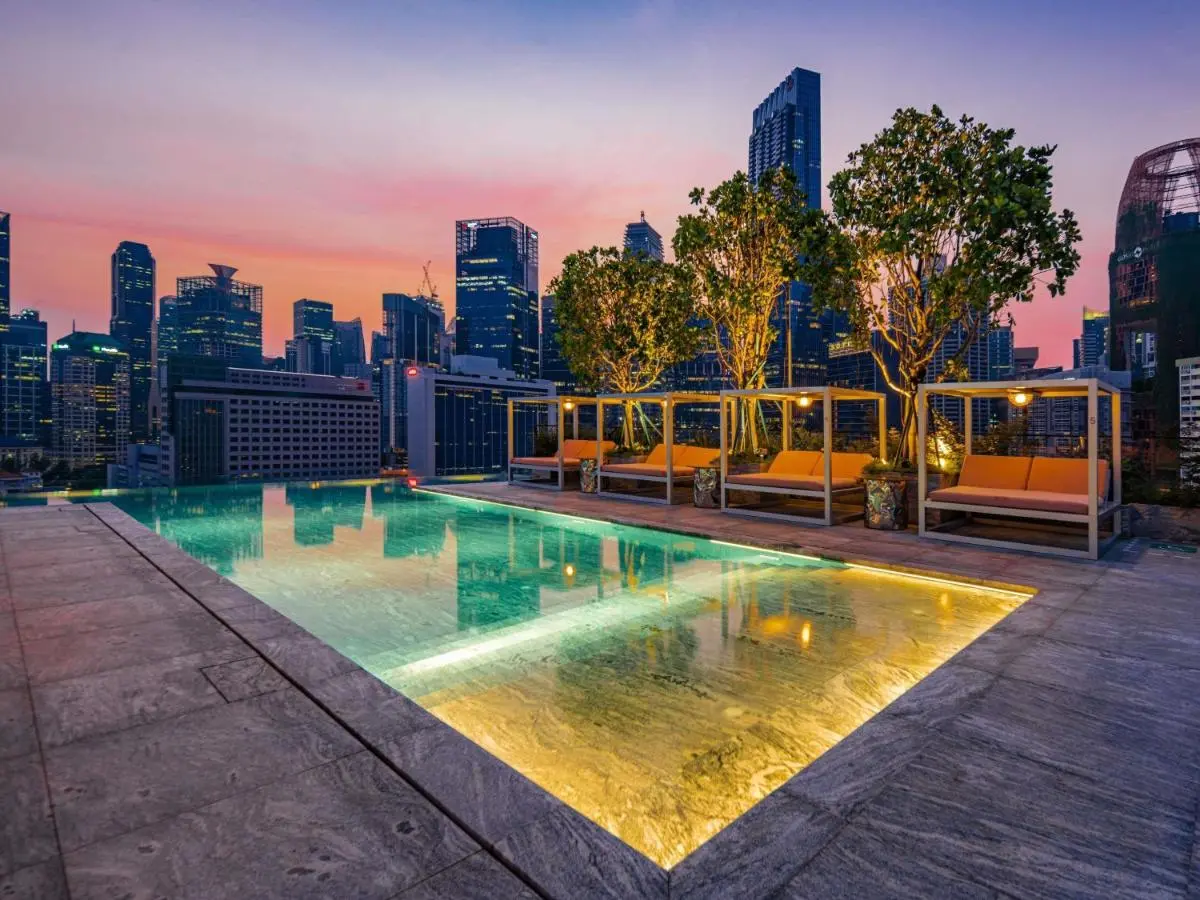 Rooftop Swimming Pool Area with Cabanas and City Skyline in Chinatown Singapore