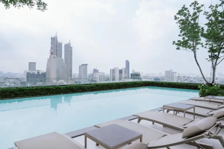 Rooftop Swimming Pool with City Skyline Views and Lounge Area in Bang Rak Bangkok