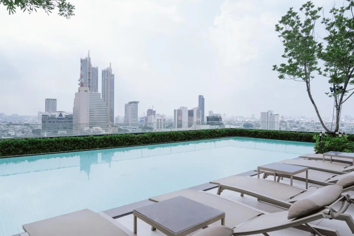 Rooftop Swimming Pool with City Skyline Views and Lounge Area in Bang Rak Bangkok