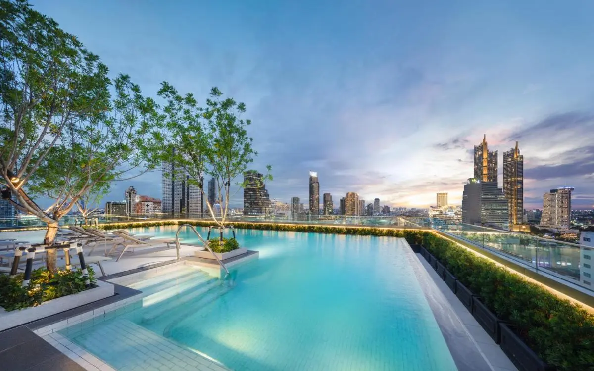 Rooftop Swimming Pool with City Skyline Views and Lounge Seating in Bang Rak