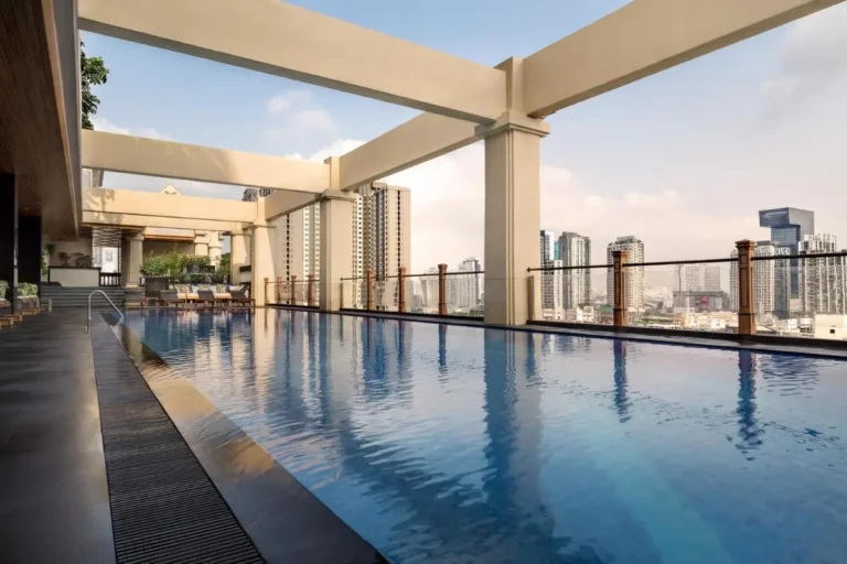Rooftop Swimming Pool with Cityscape Views and Lounge Area in Huai Khwang Bangkok