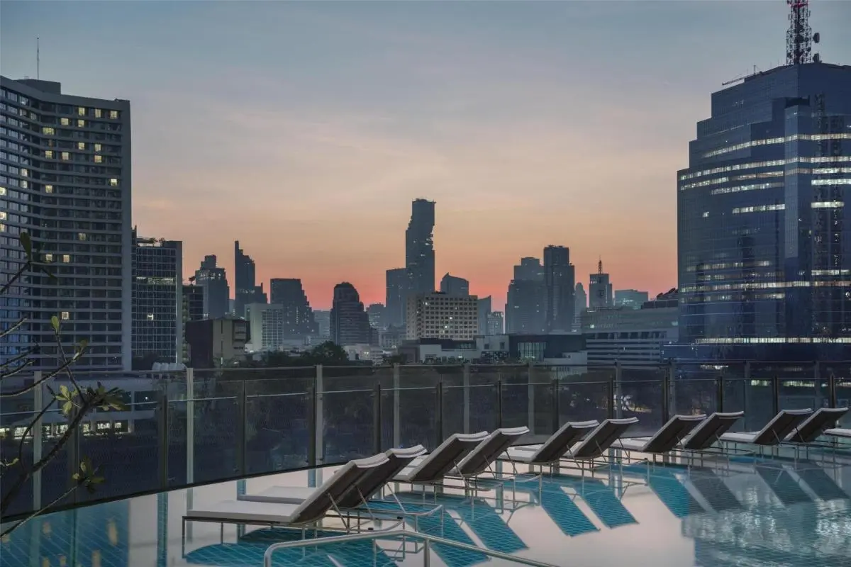 Rooftop Swimming Pool with Cityscape Views and Lounge Chairs in Khlong San Bangkok