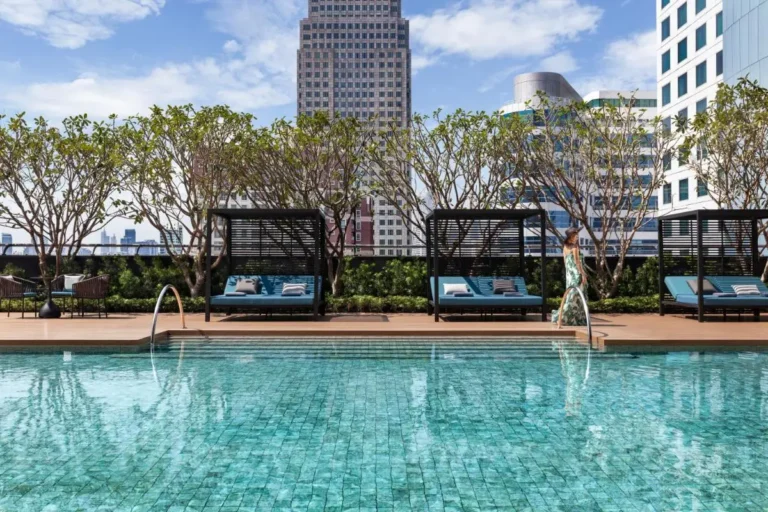 Rooftop Swimming Pool with Lounge Cabanas and Urban Views in Wattana Bangkok