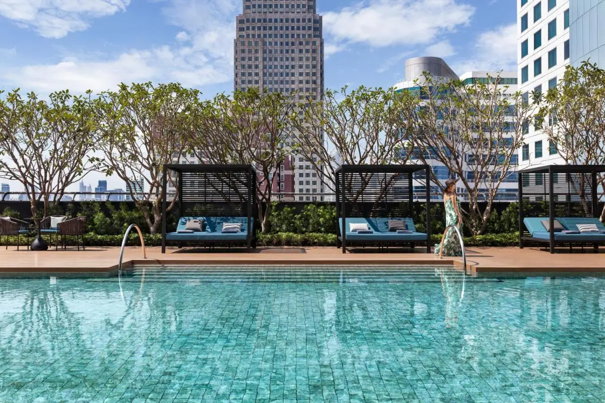 Rooftop Swimming Pool with Lounge Cabanas and Urban Views in Wattana Bangkok