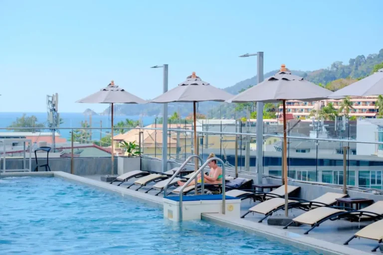 Rooftop Swimming Pool with Lounge Chairs and Ocean Views at Patong Beach