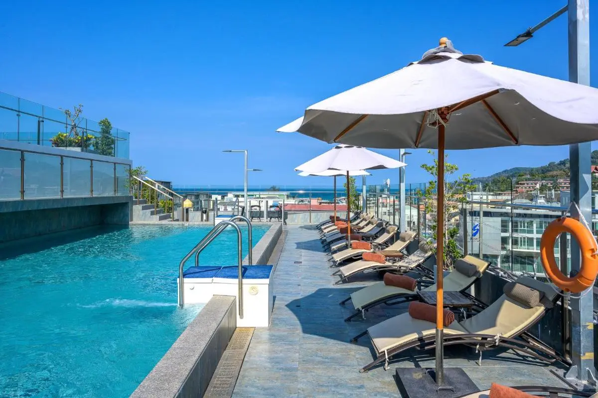 Rooftop Swimming Pool with Lounge Chairs and Ocean Views at Patong Beach