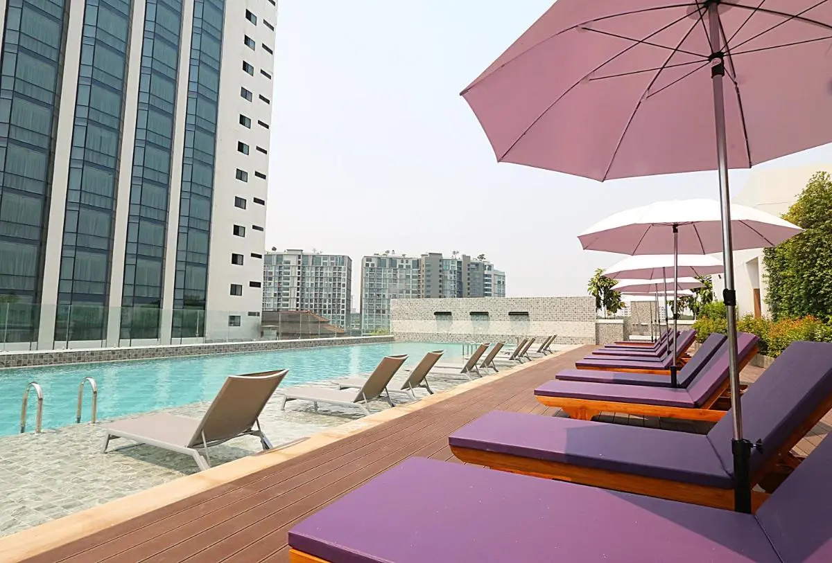 Rooftop Swimming Pool with Lounge Chairs and Umbrellas in Chang Khlan Chiang Mai