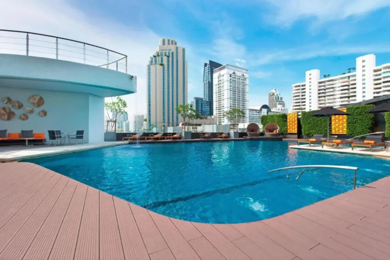 Rooftop Swimming Pool with Lounge Seating and City Views in Wattana Bangkok