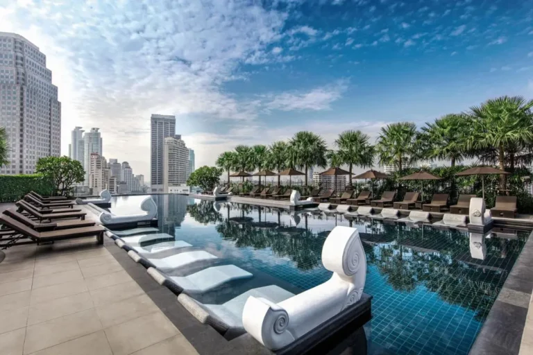 Rooftop Swimming Pool with Lounge Seating and Urban Views in Wattana Bangkok