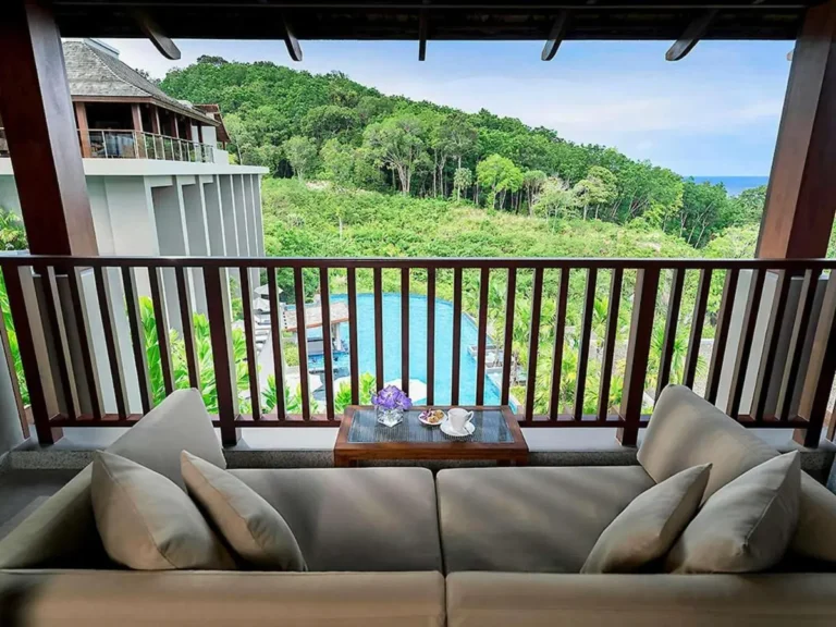 Scenic Outdoor Pool Area with Lounge Seating and Ocean Views at Patong Beach