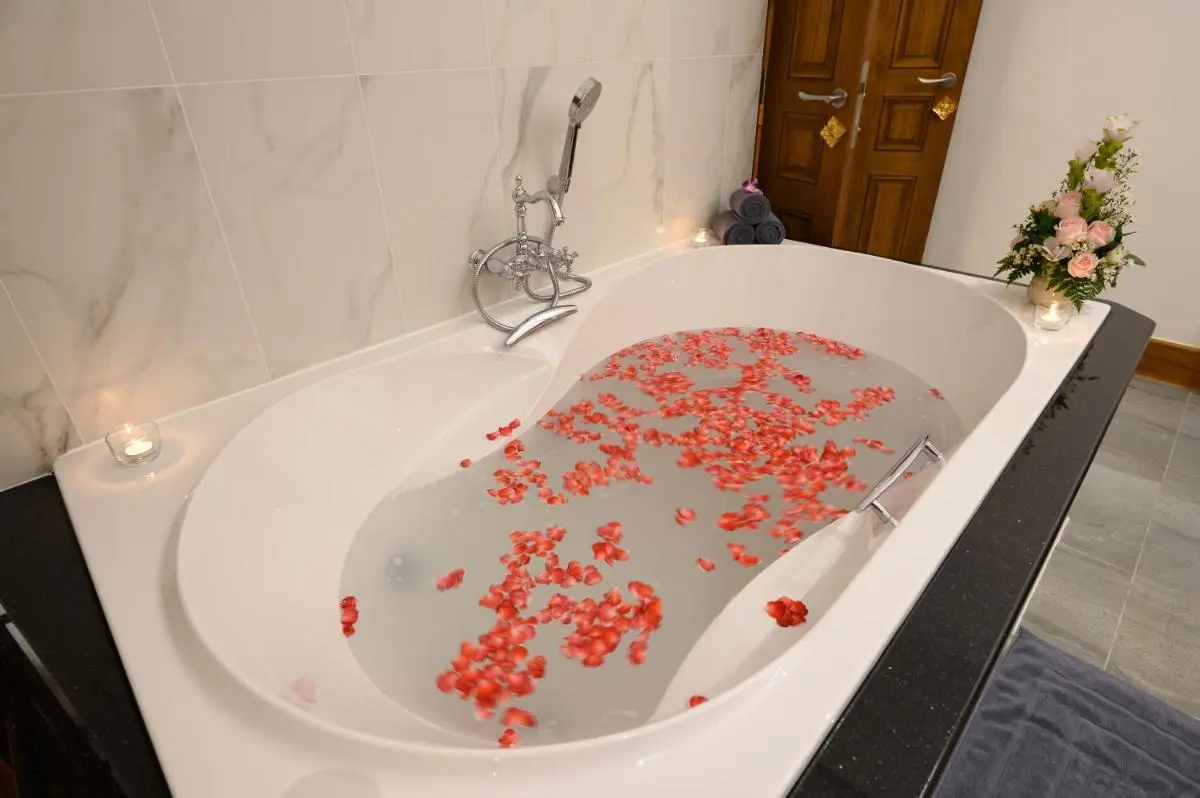 Chiang Mai Province Serene Indoor Bathtub with Flower Petals and Spa Ambiance in Chang Khlan Chiang Mai