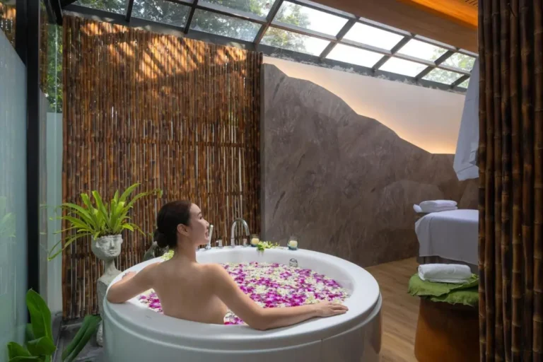 Serene Indoor Spa Room with Circular Bathtub and Natural Elements in Phuket Town