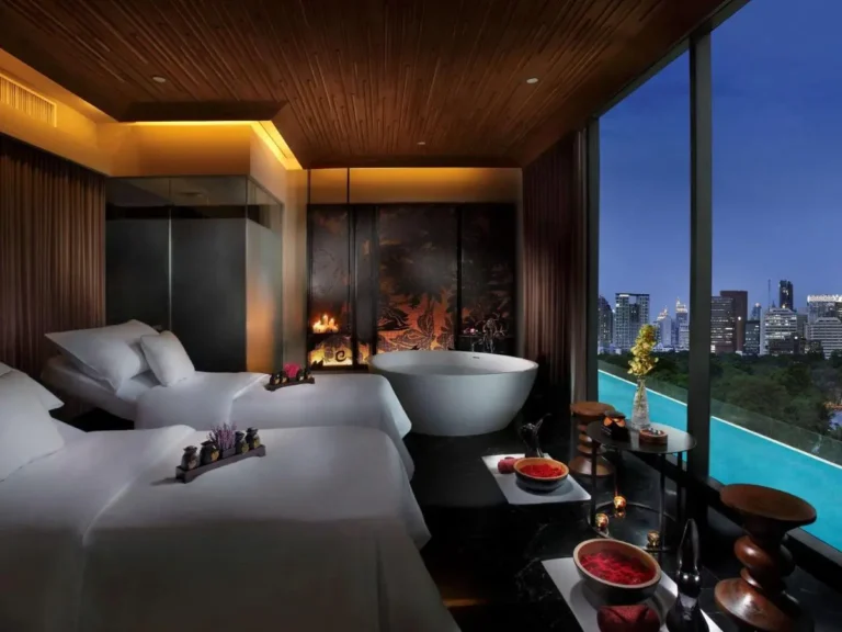 Serene Indoor Spa Room with Massage Beds and Infinity Pool View in Bang Rak