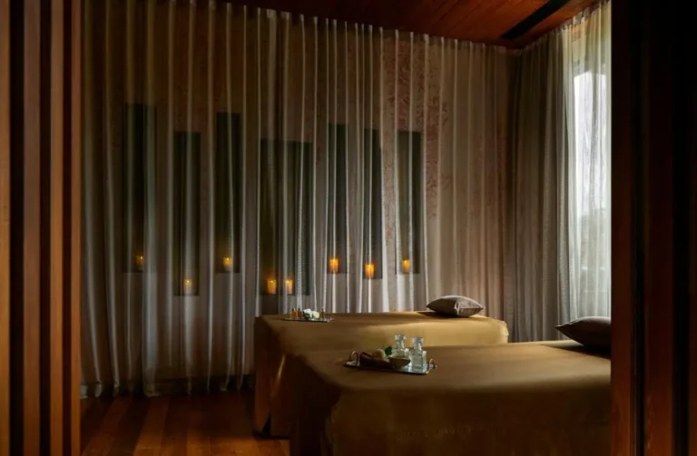 Serene Indoor Spa Room with Massage Tables and Ambient Candlelight at Panwa Beach