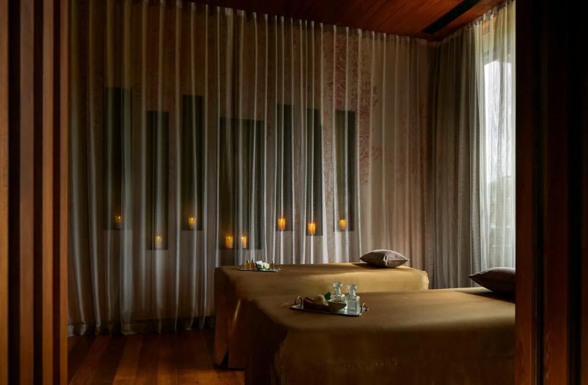 Serene Indoor Spa Room with Massage Tables and Ambient Candlelight at Panwa Beach