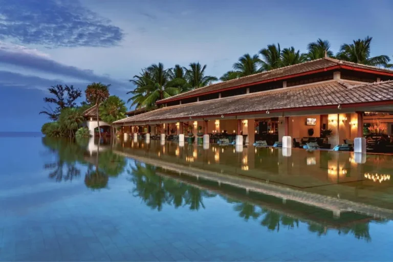 Serene Infinity Pool and Open-Air Lounge at Mai Khao Beach at Dusk