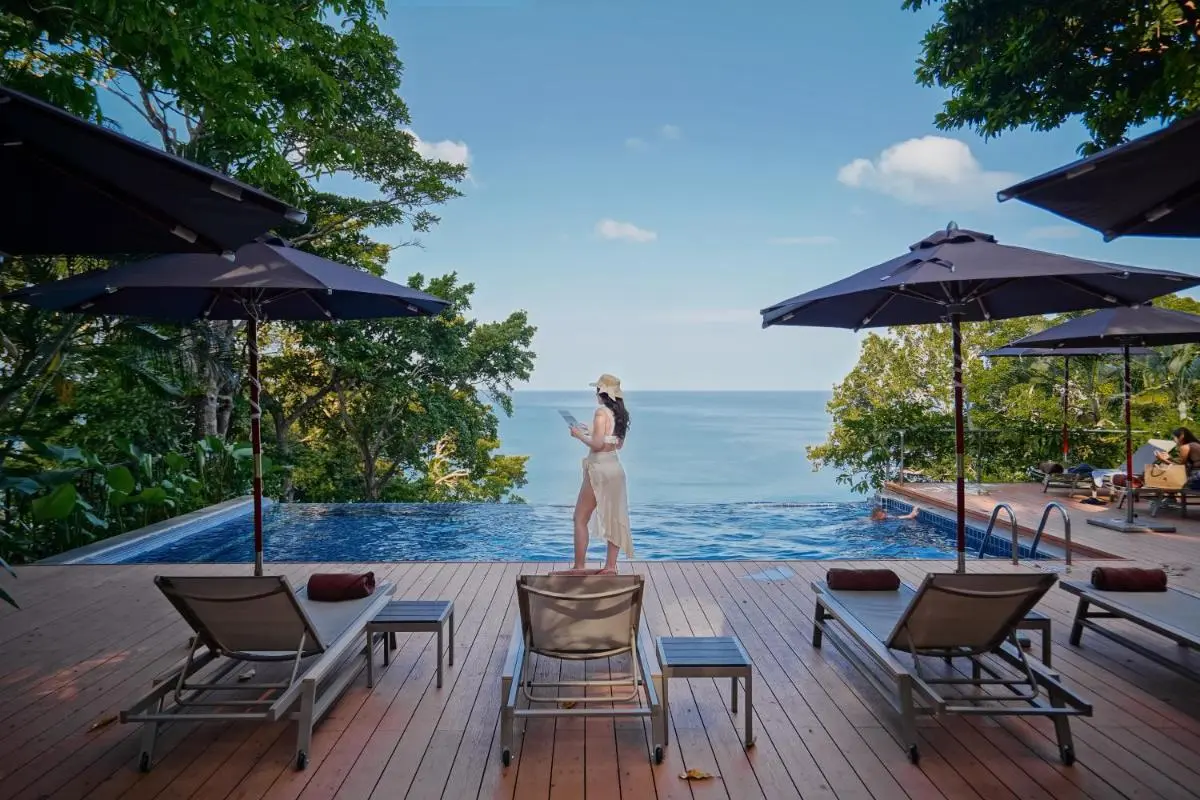 Serene Infinity Pool Overlooking Ocean at Karon Beach with Relaxing Loungers