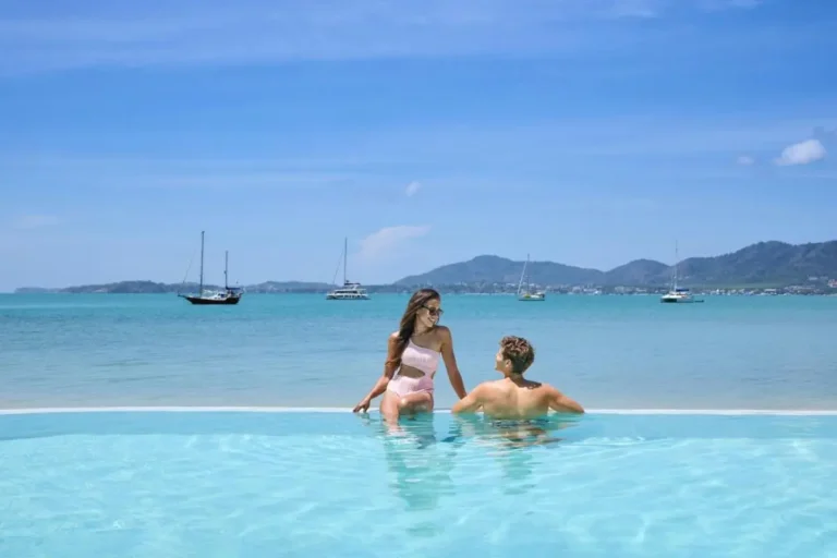 Serene Outdoor Infinity Pool Overlooking Turquoise Sea and Coastal Hills at Panwa Beach