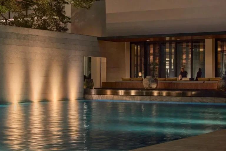 Serene Outdoor Pool Area with Ambient Lighting and Seating in Sathorn City
