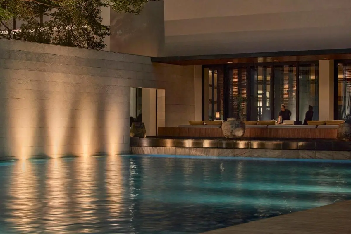Bangkok Province Serene Outdoor Pool Area with Ambient Lighting and Seating in Sathorn City