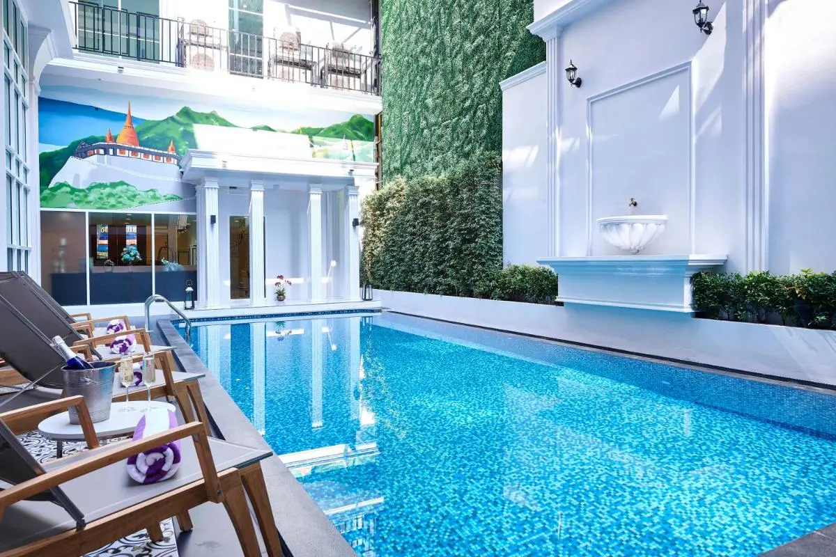 Villa De Pranakorn Serene Outdoor Swimming Pool and Relaxation Area with Lounge Chairs in Phra Nakhon Courtyard Thailand