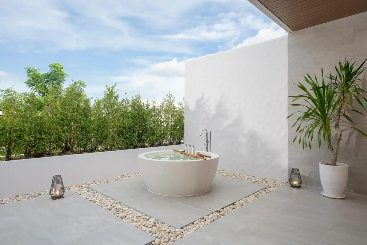 Serene Outdoor Wellness Area with Circular Bathtub and Natural Elements at Mai Khao Beach