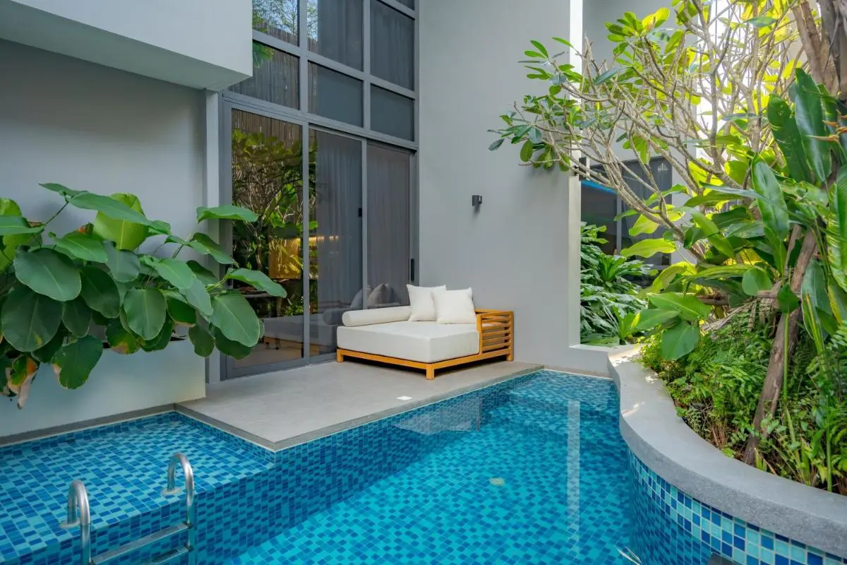 Small Outdoor Pool Area with Lounge Chair and Lush Greenery at Bang Tao Beach