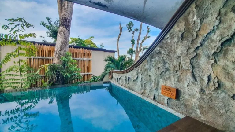 Small Rectangular Pool with Clear Water and Stone Wall in Phuket Town