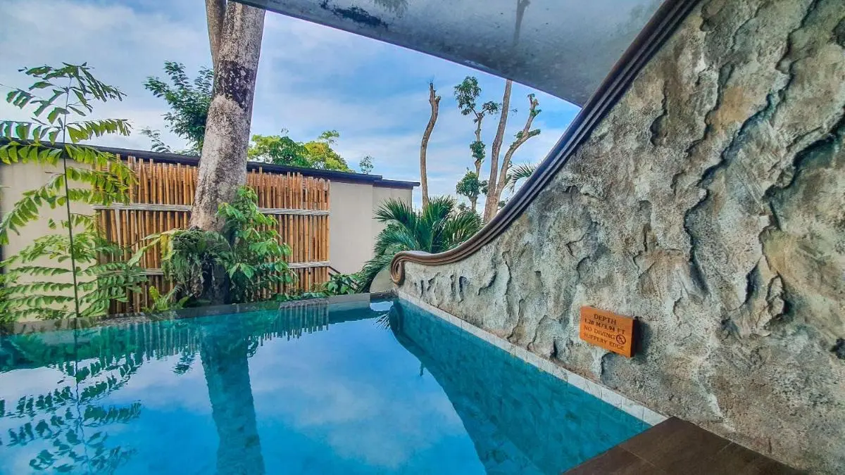 Small Rectangular Pool with Clear Water and Stone Wall in Phuket Town